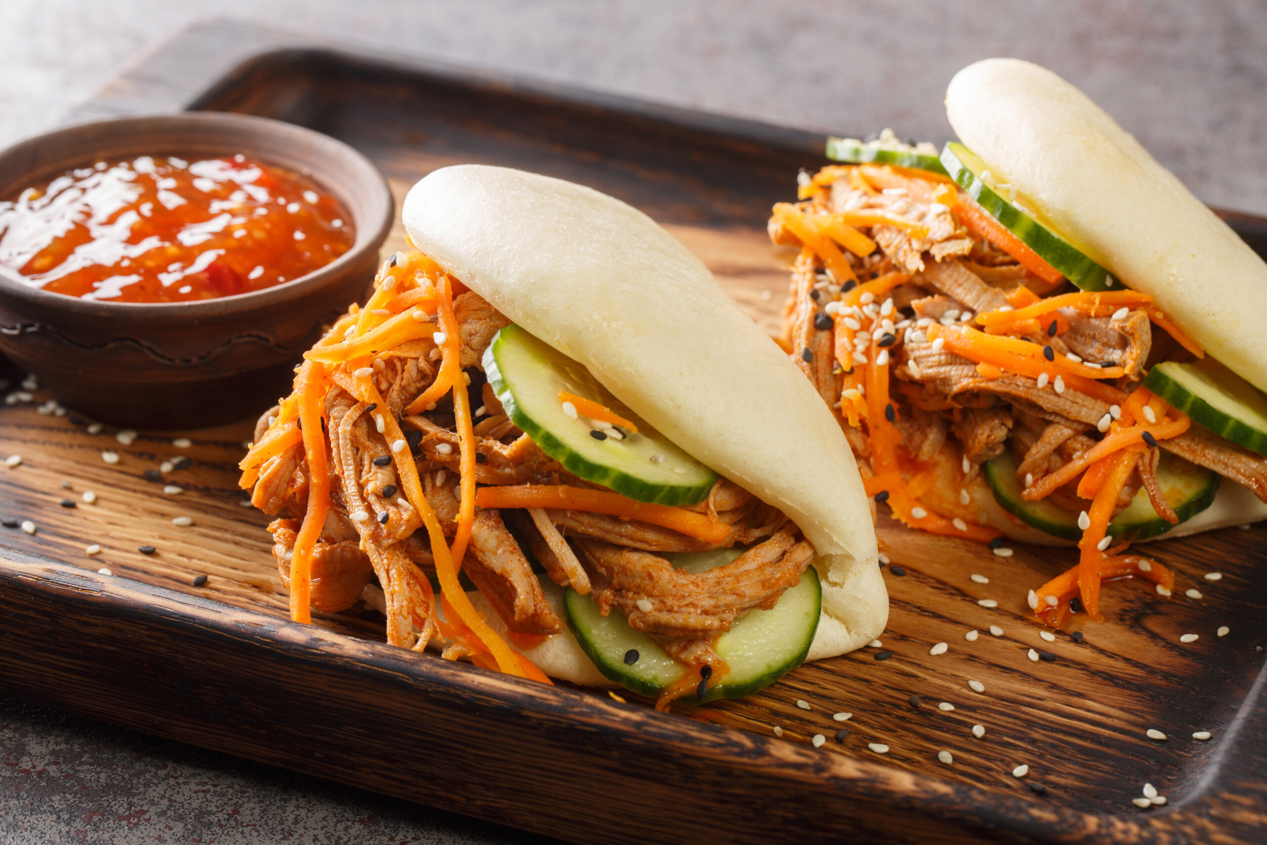 Delicious steamed bao buns sandwiches with pulled pork close-up